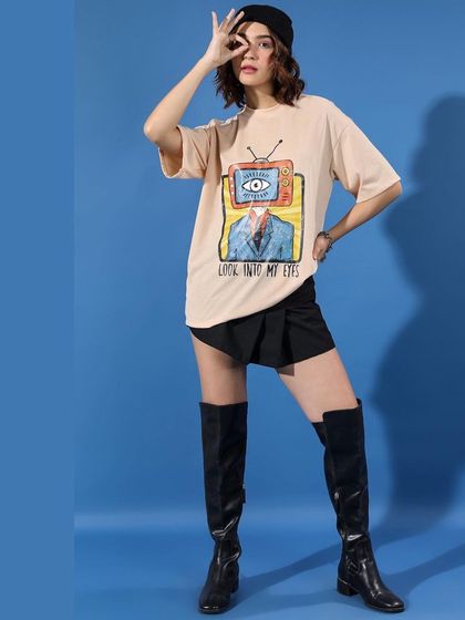 This is the same streetwear outfit, showing how a strong pose can emphasize the styling. The combination of the quirky graphic tee and dramatic boots makes for a memorable e-commerce photo.