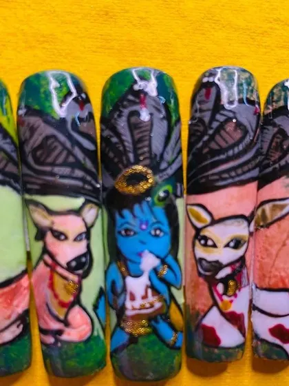 This set of nails tells a story from Krishna's life, showcasing incredible miniature painting skills.