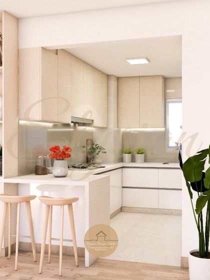 This open-concept kitchen features a small breakfast counter, perfect for quick meals. The design maintains the clean beige and white theme, seamlessly connecting the kitchen to the rest of the living space.