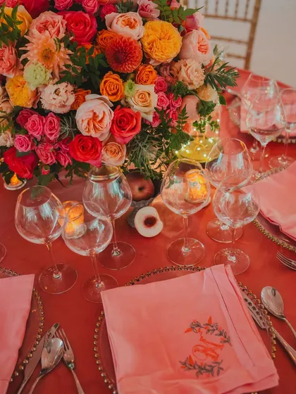 An exquisite table setting featuring custom-embroidered napkins with the couple's initials, adding a touch of bespoke luxury to the dining experience.