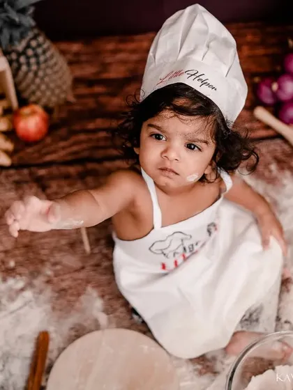 This little chef is taking a moment to consider her next culinary creation. I capture both the messy action and the sweet, thoughtful expressions in between.