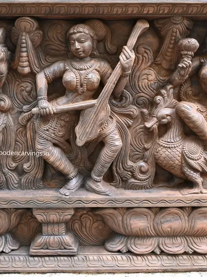 This detail shows an Apsara playing a stringed instrument, accompanied by a hamsa bird. The composition is flowing and harmonious, reflecting the musical theme of the panel.