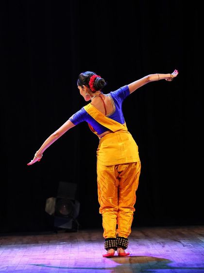 A view from the back, showcasing the elegant lines of the arms and the detailed finish of the costume and hairstyle, which are integral parts of a performance.