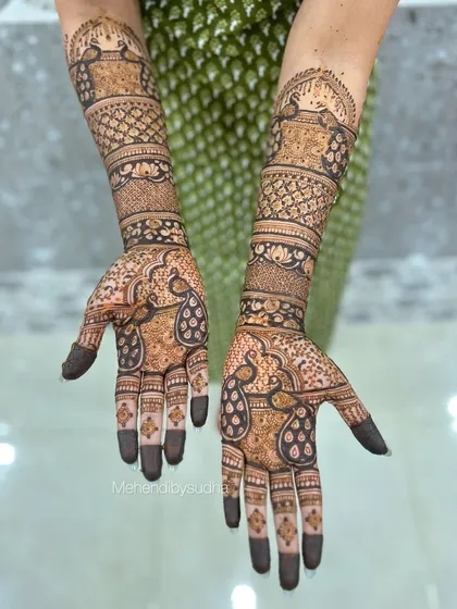 A clear, top-down view of the symmetrical peacock engagement mehendi.