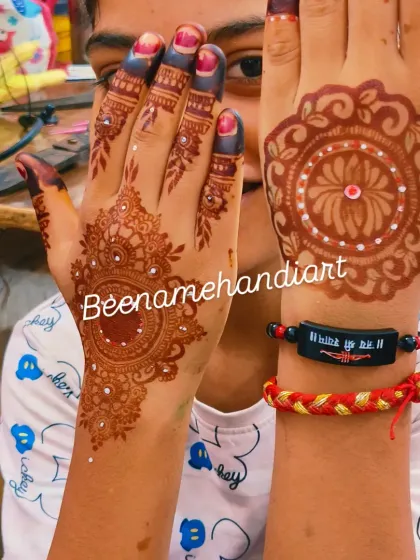 A simple yet beautiful mandala design on one hand and a more detailed traditional pattern on the other.
