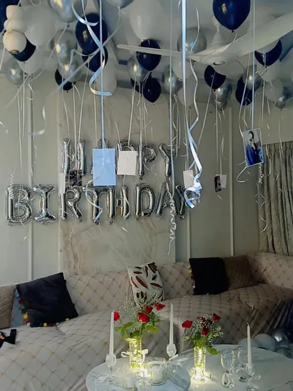 The complete romantic room setup, combining balloon decor with intimate table settings for a perfect celebration.