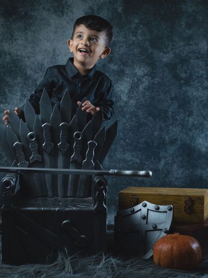 A happy king on his Iron Throne. This toddler is clearly enjoying his reign.
