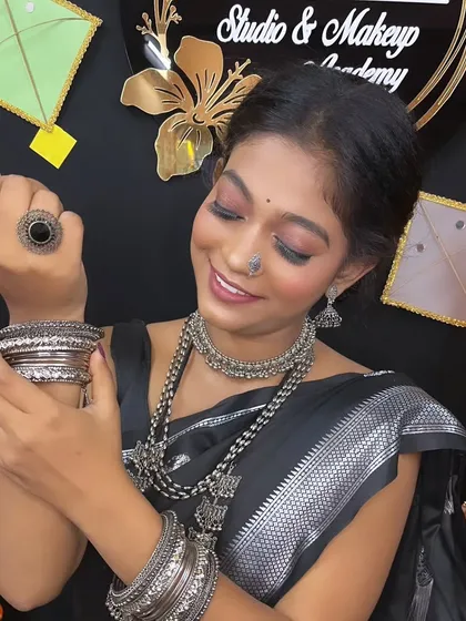 The model admiring her bangles, a shot that highlights the beautiful silver accessories.