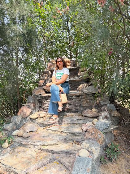 Wander often, style always. Sitting on a rock formation, this comfortable yet stylish outfit is perfect for a travel day that involves a bit of adventure.