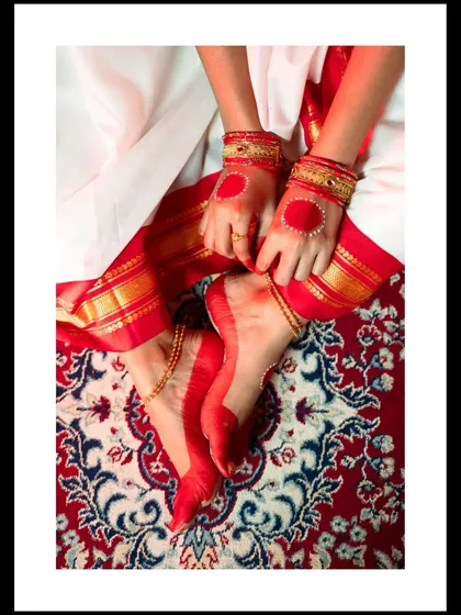 The beauty of Indian culture is in the details. For this Durga Puja shoot, I wanted to highlight the significance of 'Alta', the red dye that adorns the hands and feet, set against a traditional carpet. It’s a small detail that tells a big cultural story.