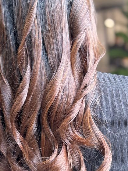 A detailed view of the caramel-toned waves, showing the intricate blend of colors and the soft, bouncy texture.
