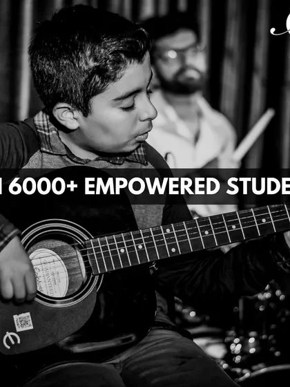 Join a community of over 6,000 students who have grown with us. This photo captures the passion of one of our young guitarists.