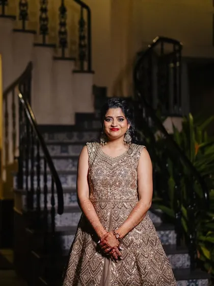 A series of photos from a Sangeet night in Goa. This look features a classic combination of smokey eyes and red lips, paired with a side-swept curly hairstyle, creating a glamorous and festive vibe.