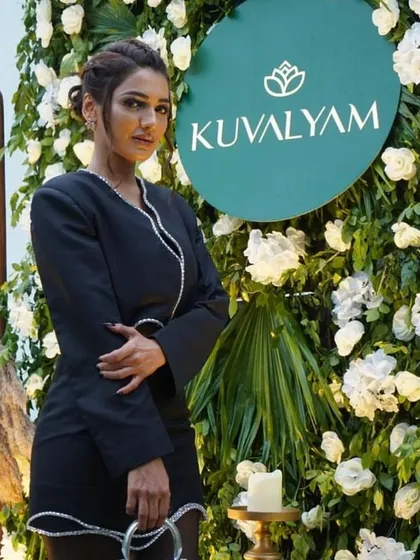 A guest at the 'Kuvalyam' brand launch. The floral wall provided a beautiful and professional photo opportunity, ensuring great visibility for the brand on social media.