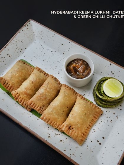 Hyderabadi Keema Lukhmi, a savory pastry filled with spiced minced meat, served with dates and green chilli chutney. This was a highlight of our special Ramzan menu.
