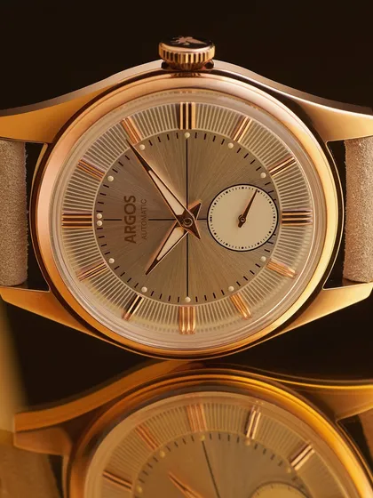 A classic hero shot. The Argos watch is presented with its reflection, creating a sense of elegance and balance. The lighting is carefully controlled to define the watch's shape and show off the sunray finish on the dial.
