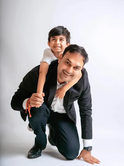 A fun piggyback ride for a son on his dad's back. Capturing these playful father-son moments is always a joy.