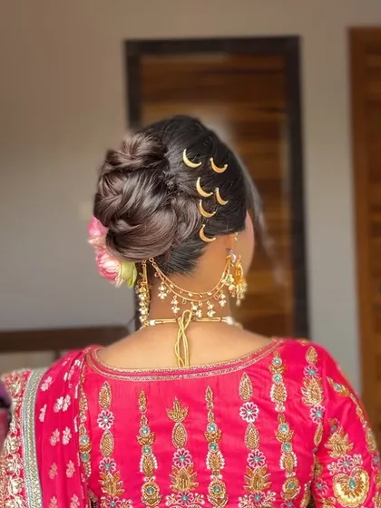 Another angle of the creative messy bun, highlighting the crescent moon accessories and the texture created to give the style volume and interest.