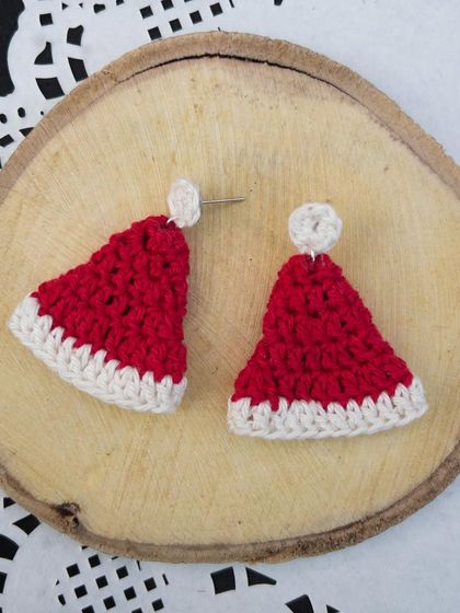 A product shot of the Santa cap stud earrings. They are so festive and fun for the holiday season.