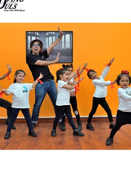 Our instructor leading the kids' class with fun and engaging choreography. We make learning to dance an adventure.
