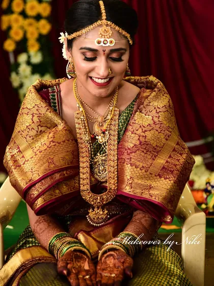A beautiful portrait of Pooja during her wedding rituals. The makeup highlights her features without looking heavy, perfect for the traditional setting.