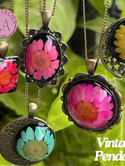 A collection of vintage-style floral pendants, a perfect gift for a sister on Rakshabandhan. Each pendant features a real flower preserved in resin with an antique-finish frame.