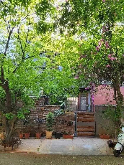My studio as seen from the street in spring, almost hidden by the lush trees. I designed the building to coexist with its green surroundings, allowing nature to be the true facade.