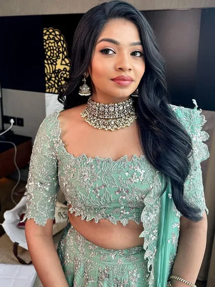 A fresh and modern engagement look. The makeup is kept soft and radiant to complement this stunning mint green lehenga.