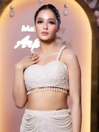 A glamorous makeup look perfect for a cocktail party or reception. The focus is on a flawless base and defined eyes, paired with a modern, chic top.