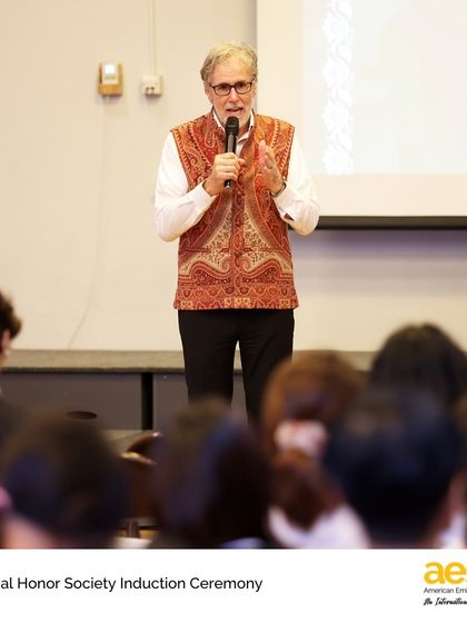Our school director addresses the new inductees of the AES Honor Society. Membership in these societies is one of the highest honors a student can achieve, recognizing their holistic excellence.