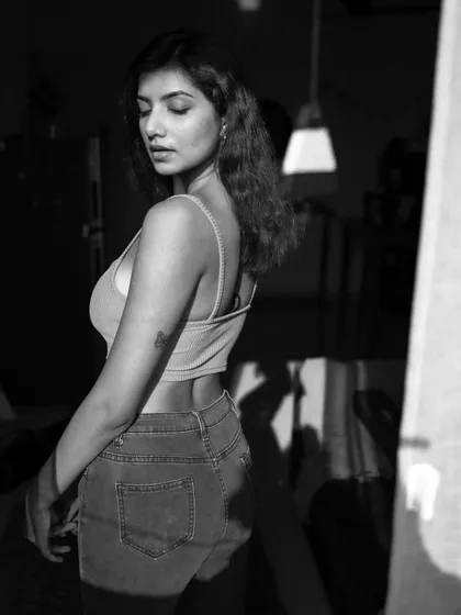 An indoor series using shadows from a window to create patterns on the subject. This shows a creative approach to using natural light in a domestic setting.