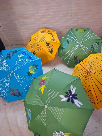 A colourful collection of finished umbrellas from one of our workshops. Each one is a unique piece of art, reflecting the personality of the child who painted it.