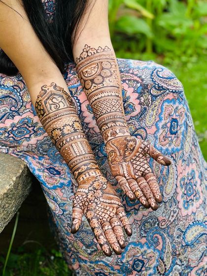 A full-coverage bridal design with a variety of patterns on each arm. One arm features a bride and groom, while the other has personalized initials, telling a complete story.
