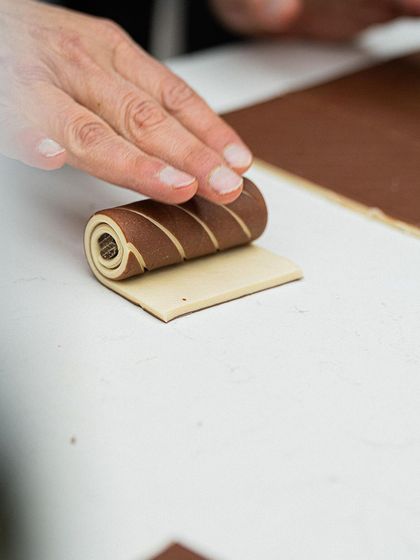 Chef Bachour rolls a bi-colored dough, a key step in creating visually stunning laminated pastries with distinct layers.
