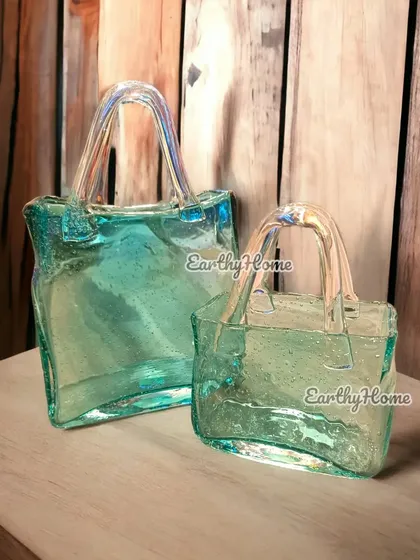 My blown glass handbag vases are a truly unique and artistic decor item. They look stunning with or without flowers.