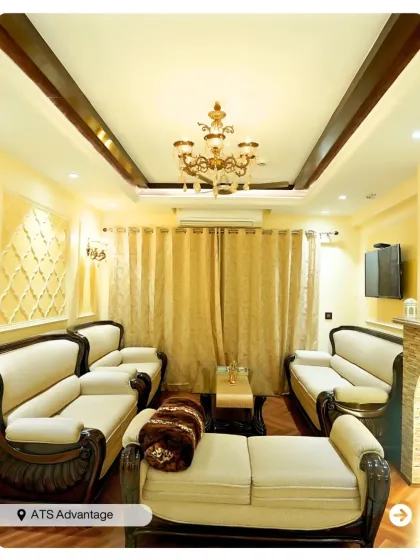 A classic and opulent living room design with carved wooden sofas and a grand chandelier. The warm, golden tones create a regal and inviting ambiance.