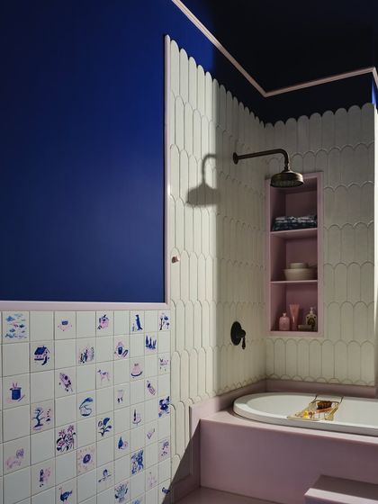 A detail of the artist's bath, showing the wall of illustrated tiles hand-painted during lockdown. Each square is like a diary page in ceramic, capturing fleeting moments and making them permanent.