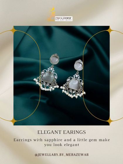 An elegant showcase of the grey stone dangle earrings. The caption highlights how the sapphire-like stone and gems create an elegant look.