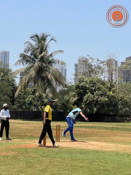 A player bowls during a sunny day at the PPL, with the umpire and batsman ready for the delivery.