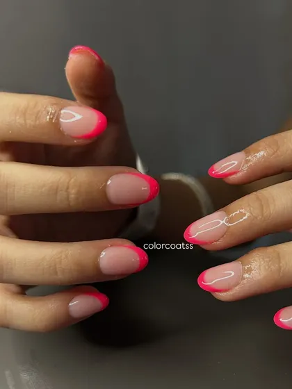 A full view of this perfectly executed neon pink French manicure. The lines are crisp and the shape is consistent, which is the kind of detail I focus on for every set.