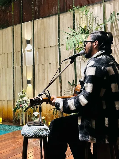 Performing a solo acoustic set by the poolside for a private gathering. This setup is ideal for creating a sophisticated yet relaxed atmosphere for exclusive events, corporate functions, or high-end private parties.