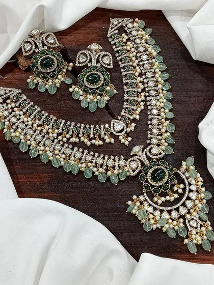 A beautiful layered set combining a choker and a longer necklace, featuring green stones and pearls.