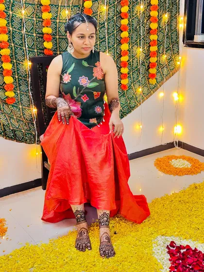 A happy client showing her festive foot mehendi, perfect for a haldi ceremony or any celebration.
