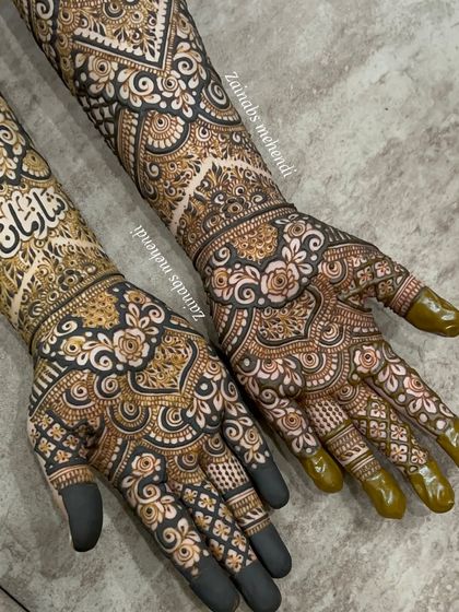 A closer look at the symmetry and detail in Tasmiya's bridal henna. Both hands are adorned with matching patterns, creating a perfectly balanced look.