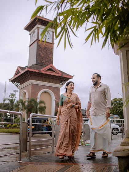 A portrait with the iconic Mangaluru clock tower in the background, rooting the love story in a specific, meaningful place.