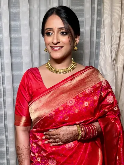Some looks are truly timeless, and a classic red silk saree with bold kohl-rimmed eyes is one of them. For this reception look, we focused on creating a clean, radiant base to let the traditional elements shine, resulting in pure, elegant beauty.
