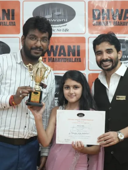 Our instructors presenting a trophy to a student for her outstanding creative work.