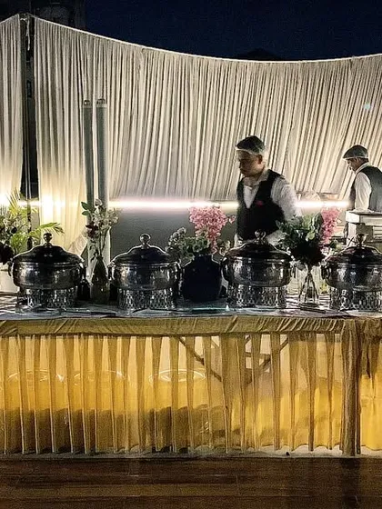 My team setting up for an evening event in DLF Phase 4. The combination of warm lighting and professional staff ensures a welcoming atmosphere as guests arrive.