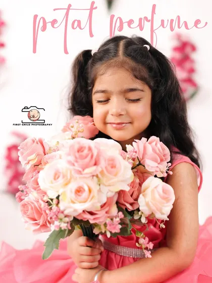 The sweet innocence of a little girl smelling a bouquet of pink roses. This portrait is from a themed third birthday studio shoot, designed to feel soft and dreamy. It’s a close-up that captures her gentle nature and the magic of being three.