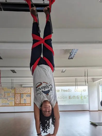 A student works on her supported inversion, building strength and confidence in our weekend aerial class.
